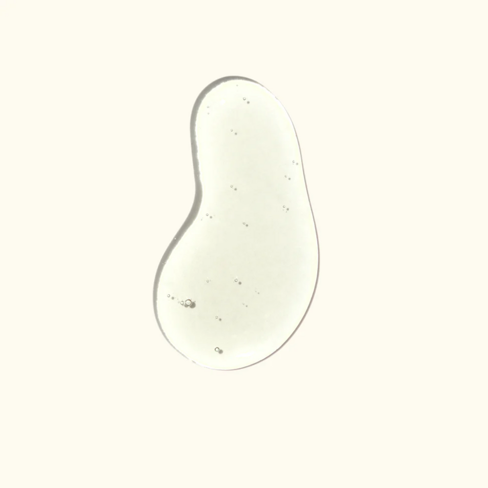 Flacon élégant Amika Water Sign Hydrating Hair Oil 50 ml, huile hydratante brillante pour cheveux secs et texturés.