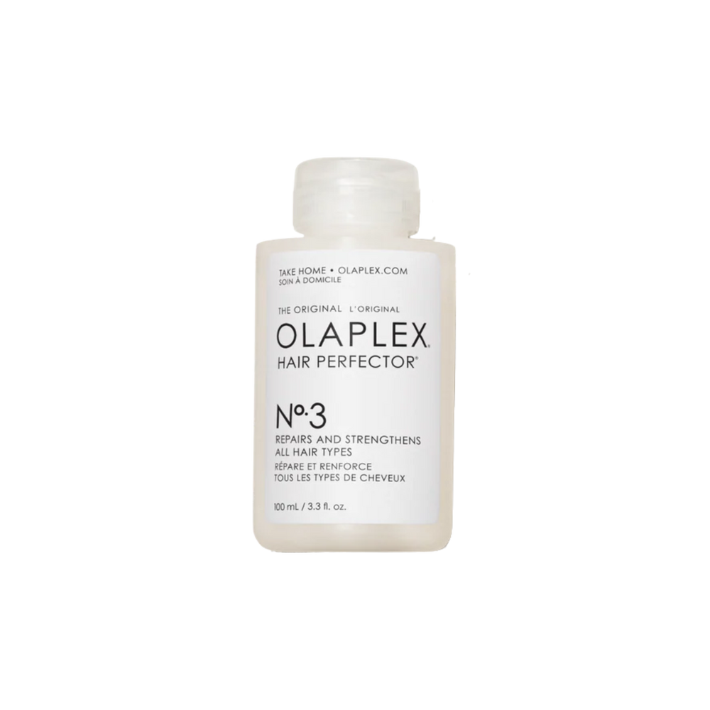 Flacon du traitement Olaplex N° 3 Hair Perfector posé sur fond neutre