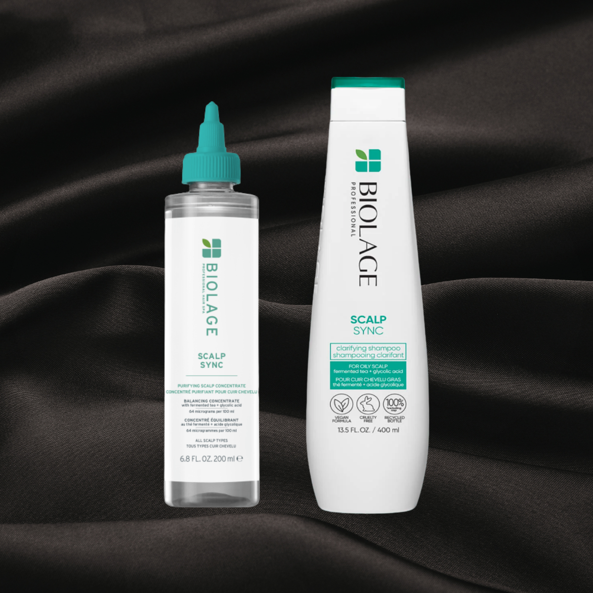 Concentré purifiant pour cuir chevelu scalp sync & Shampooing clarifiant scalp sync de la gamme Biolage disponible chez cachet urbain sur fond noir texture satin