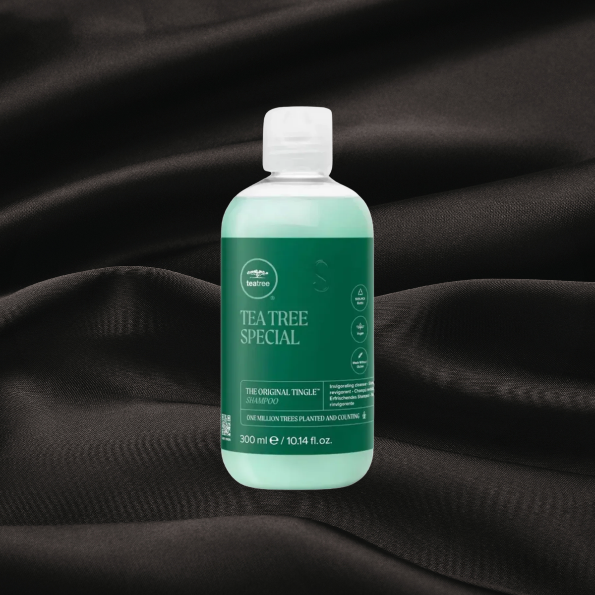 shampooing original de tea tree disponible chez Cachet urbain sur fond noir texture satin