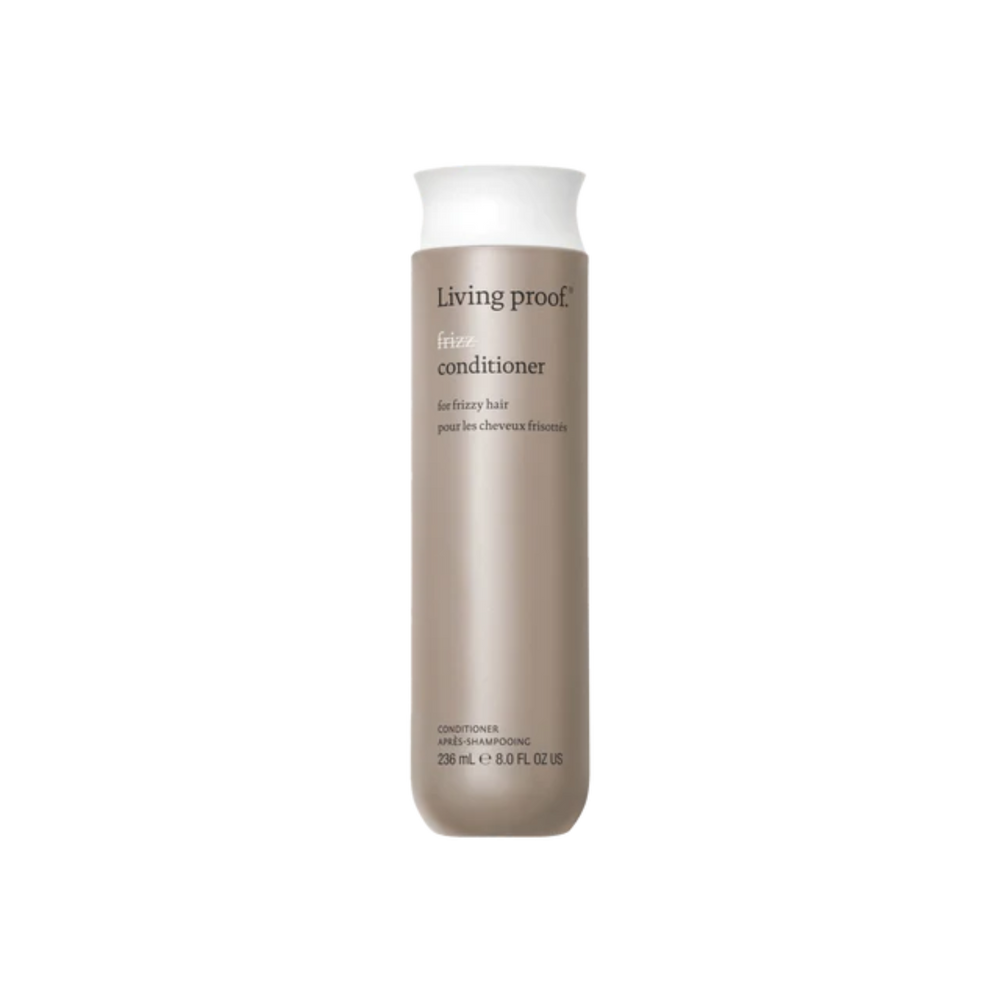 Flacon beige clair de l’après‑shampoing No Frizz Conditioner, design épuré, posé sur fond neutre évoquant douceur, contrôle des frisottis et soin capillaire professionnel.

