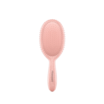 Brosse démêlante Framar Ginger avec poils flexibles et manche pailleté doré.