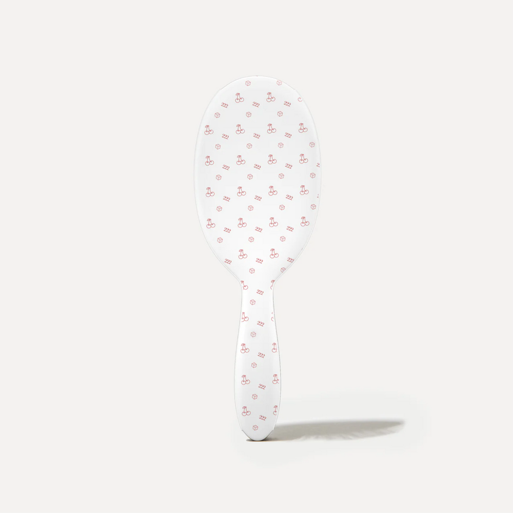 Brosse démêlante Framar Lucky blanche avec poils flexibles.