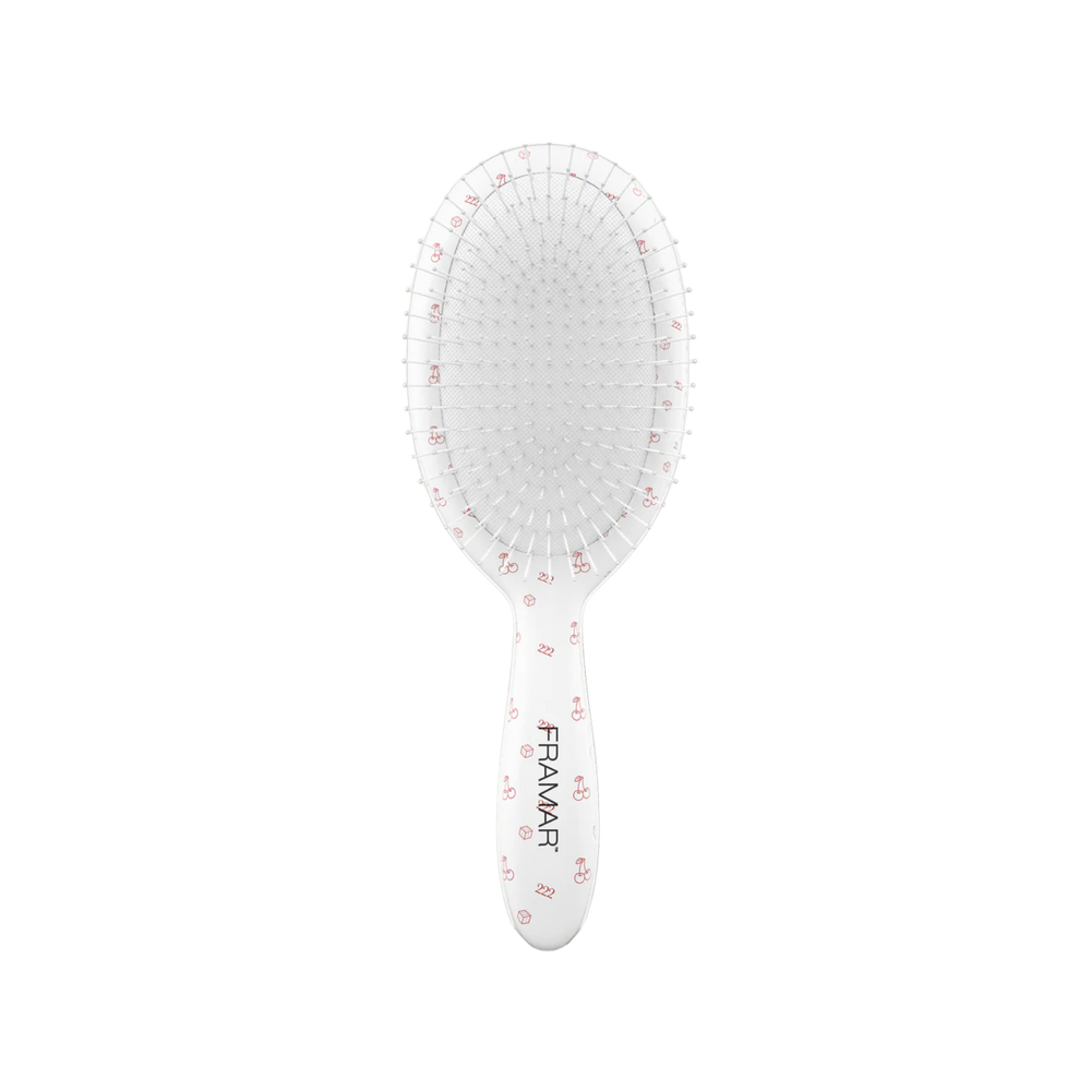 Brosse démêlante Framar Lucky blanche avec poils flexibles.