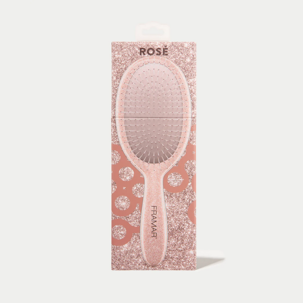 Brosse démêlante Framar Rose Gold Glitter avec poils flexibles et manche pailleté rose doré.