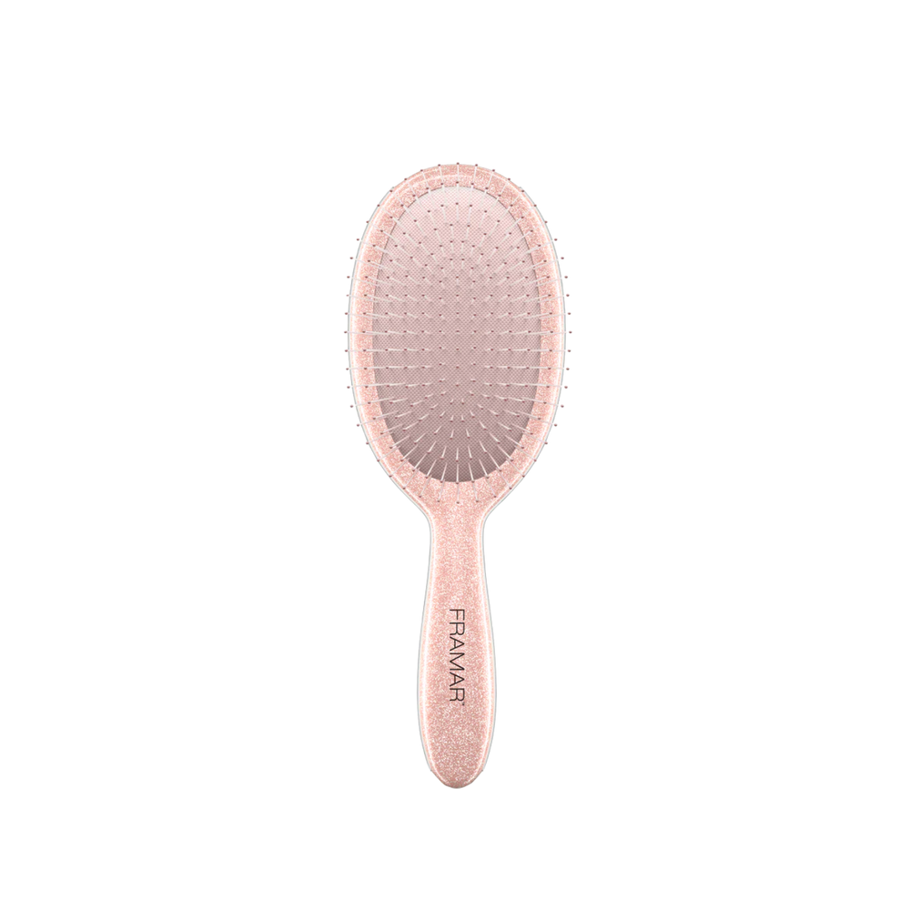 Brosse démêlante Framar Rose Gold Glitter avec poils flexibles et manche pailleté rose doré.
