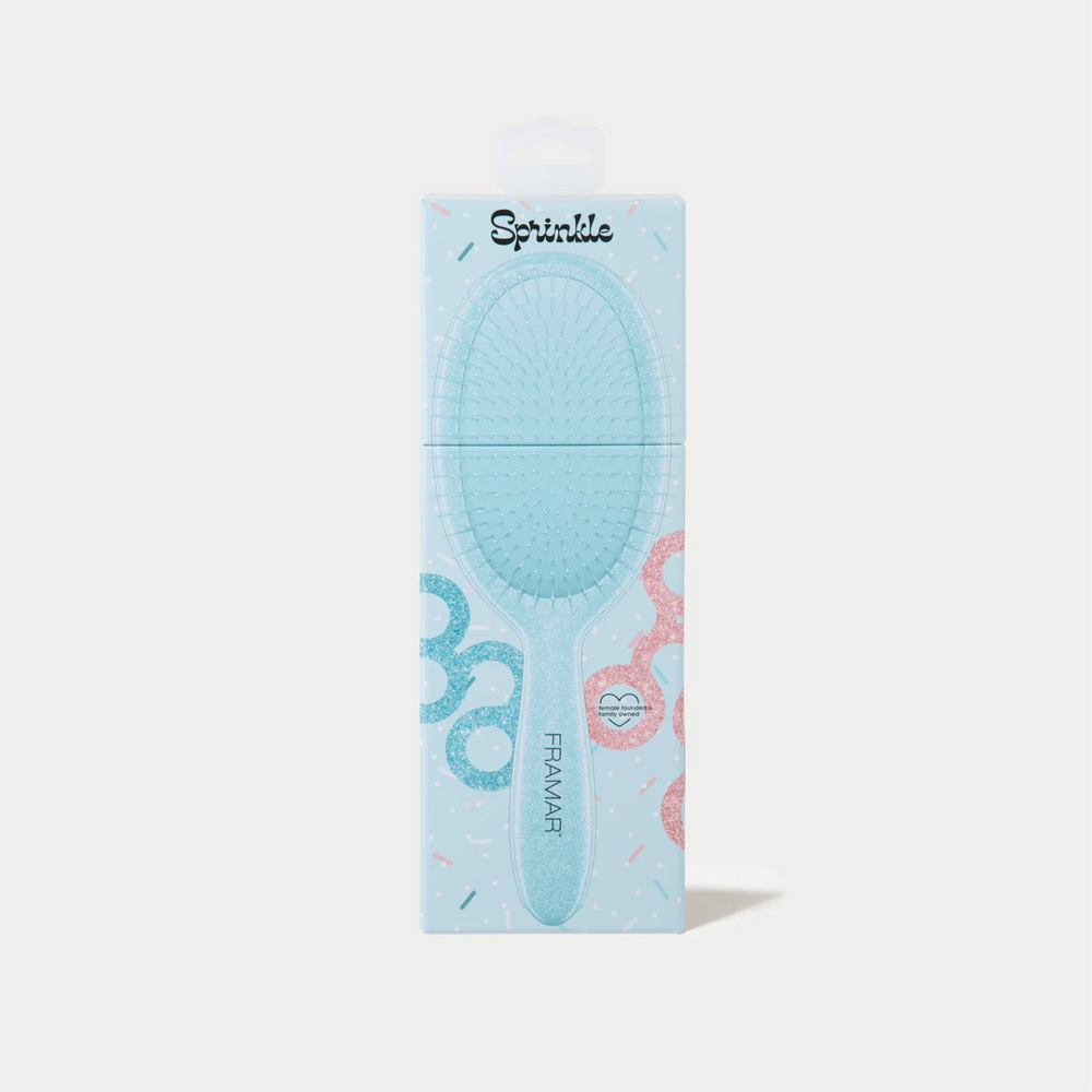 Brosse démêlante Framar Sprinkle avec manche confettis et poils souples à deux niveaux.