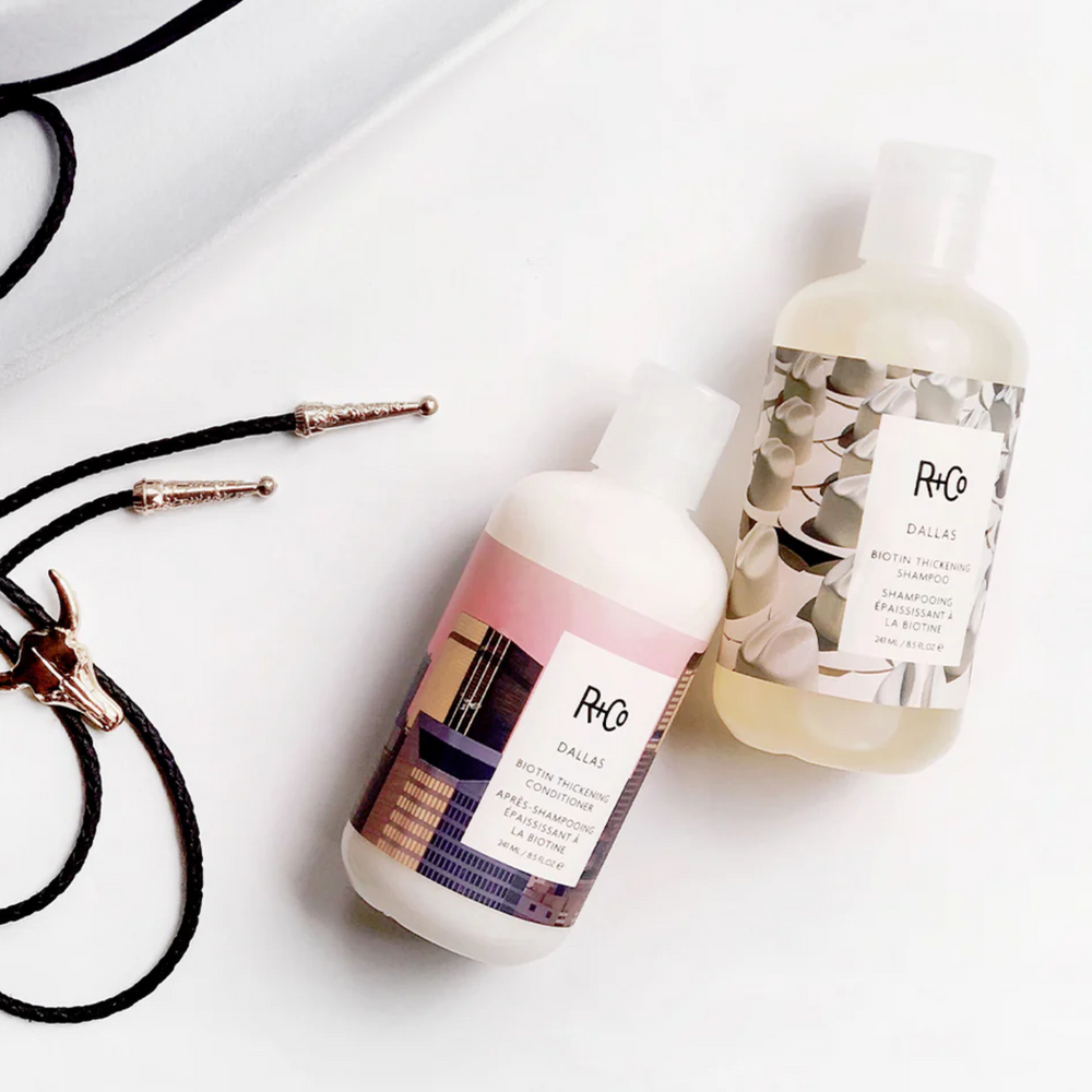 Flacon du conditionneur Dallas Biotin de R+Co, formule légère renforçante et volumisante pour cheveux fins