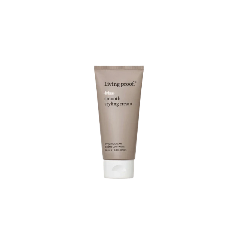Flacon beige de la crème coiffante No Frizz Smooth Styling Cream par Living Proof, posé sur fond neutre, illustrant douceur, lissage et soin anti‑frisottis.

