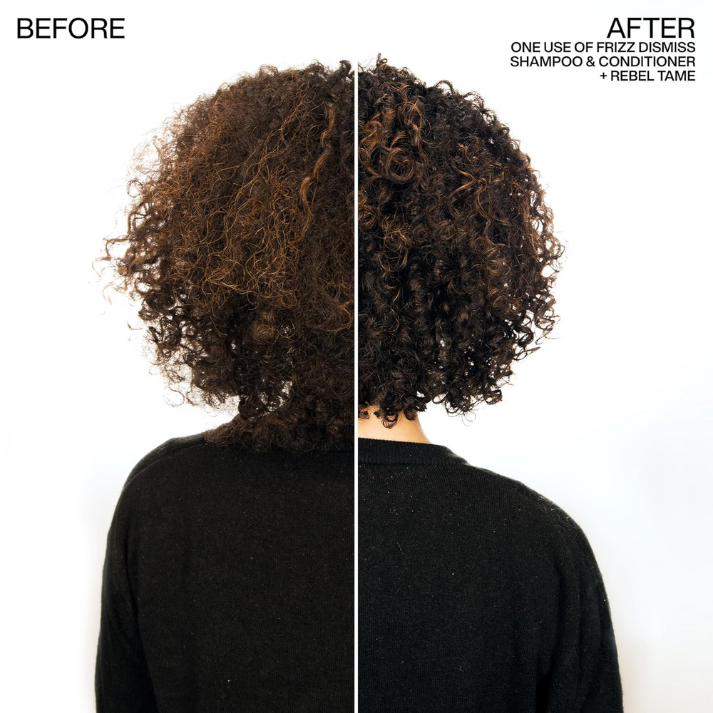 Tube de la crème sans rinçage Rebel Tame de Redken posé sur fond clair, formule anti‑frisottis enrichie en huile de babassu, protection thermique jusqu’à 230 °C.
