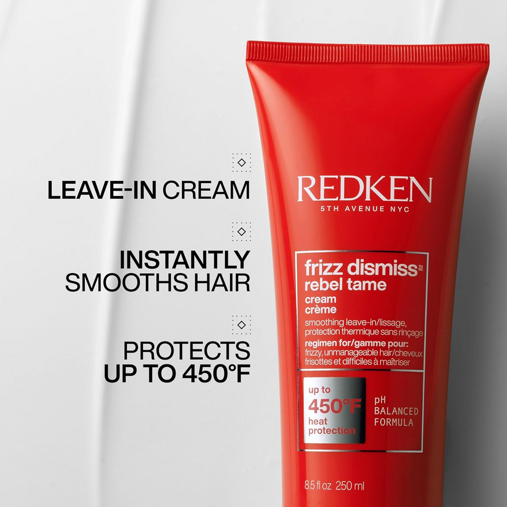 Tube de la crème sans rinçage Rebel Tame de Redken posé sur fond clair, formule anti‑frisottis enrichie en huile de babassu, protection thermique jusqu’à 230 °C.