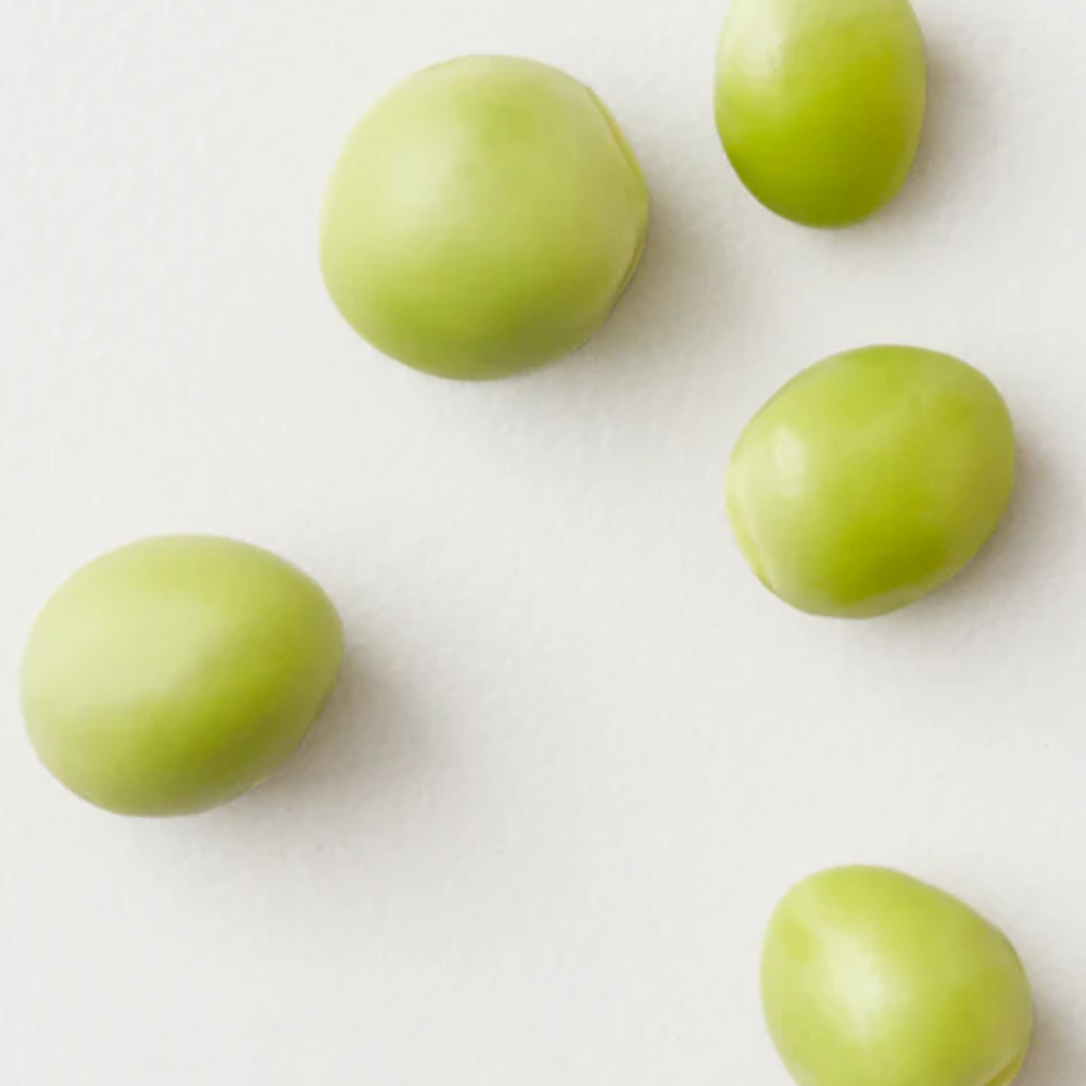 Mousse volumisante AG Care Foam Weightless Volumizer, flacon noir et cheveux volumineux en arrière-plan