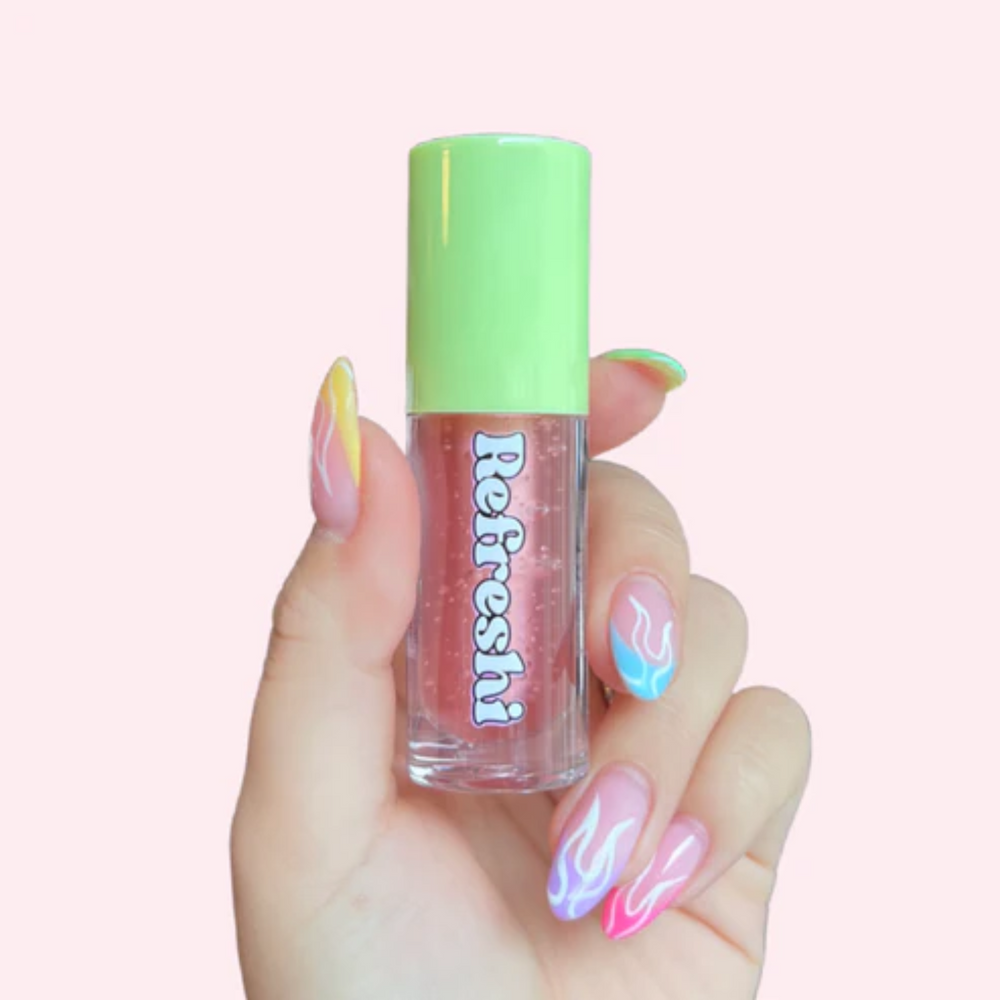 Tube d’huile à lèvres Pastèque Acidulée Refreshi sur fond rose vif, fini glossy fruité

