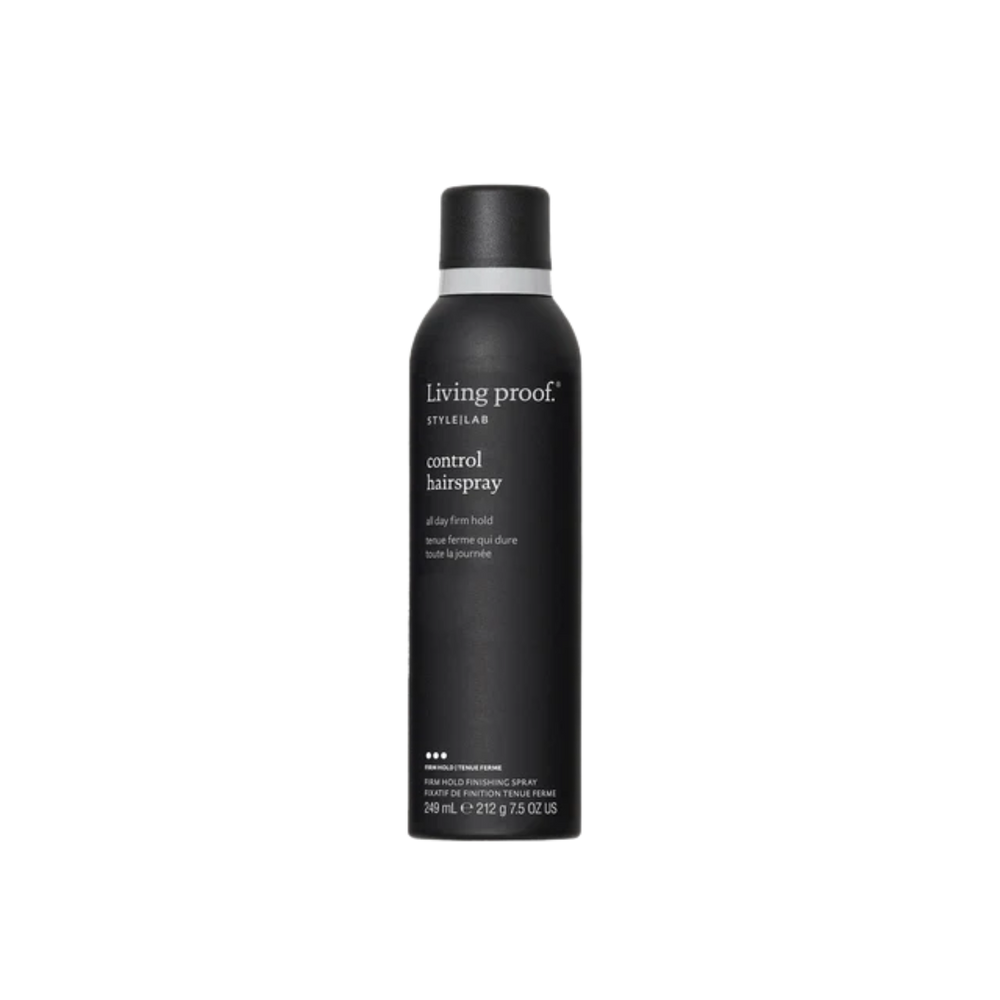 Flacon noir mat de la laque Style Lab Control Hairspray de Living Proof posé sur fond sombre, illustrant finition nette, tenue contrôlée et effet soyeux.

