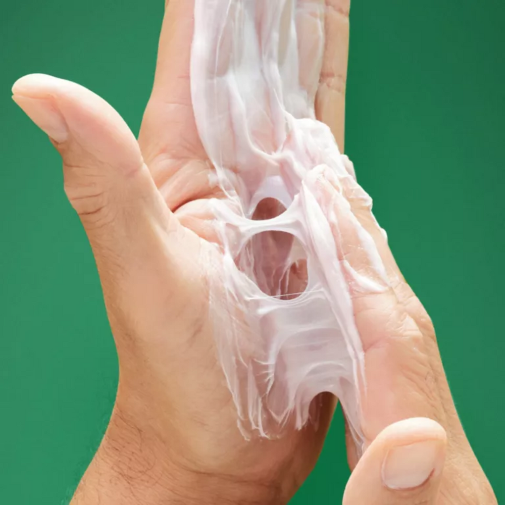 Pot de pâte fibreuse OSiS+ Thrill avec texture souple et finition brillante sur fond clair.