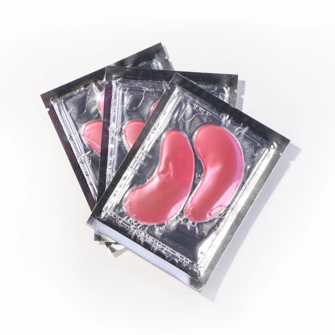 Trois paires de patchs sous les yeux Roselisa infusés à la rose égyptienne dans leur emballage gel.