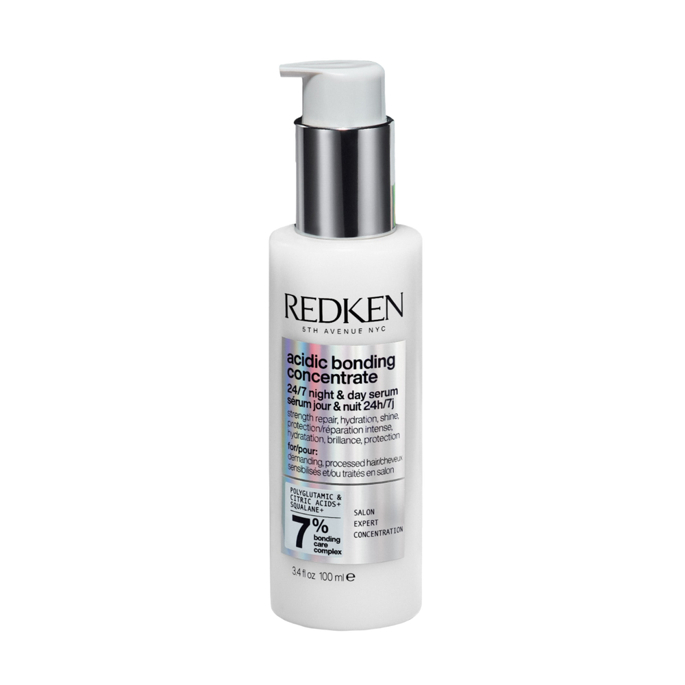 Flacon du sérum jour et nuit Redken Acidic Bonding Concentrate posé sur fond neutre.