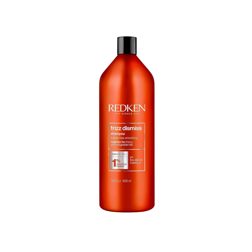 Flacon du shampooing Redken Frizz Dismiss sur fond blanc, formule anti‑frisottis sans sulfates, huile de babassu mise en avant.