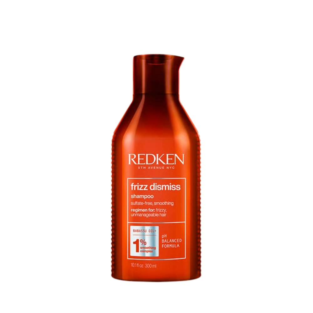 Flacon du shampooing Redken Frizz Dismiss sur fond blanc, formule anti‑frisottis sans sulfates, huile de babassu mise en avant.