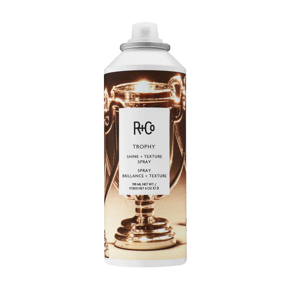 Flacon du spray Trophy Shine Texture de R+Co, spray pour volume léger, texture fine et brillance naturelle