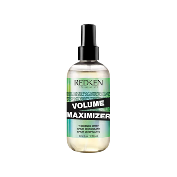 Flacon spray 250 ml du Volume Maximizer Redken posé sur fond neutre.