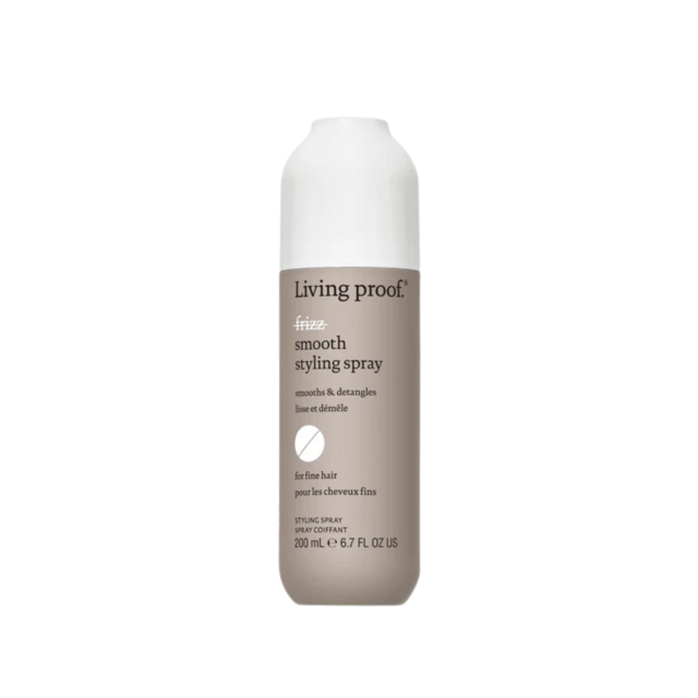 Flacon beige clair du spray coiffant No Frizz Smooth de Living Proof avec capuchon blanc, évoquant légèreté, lissage et contrôle des frisottis.

