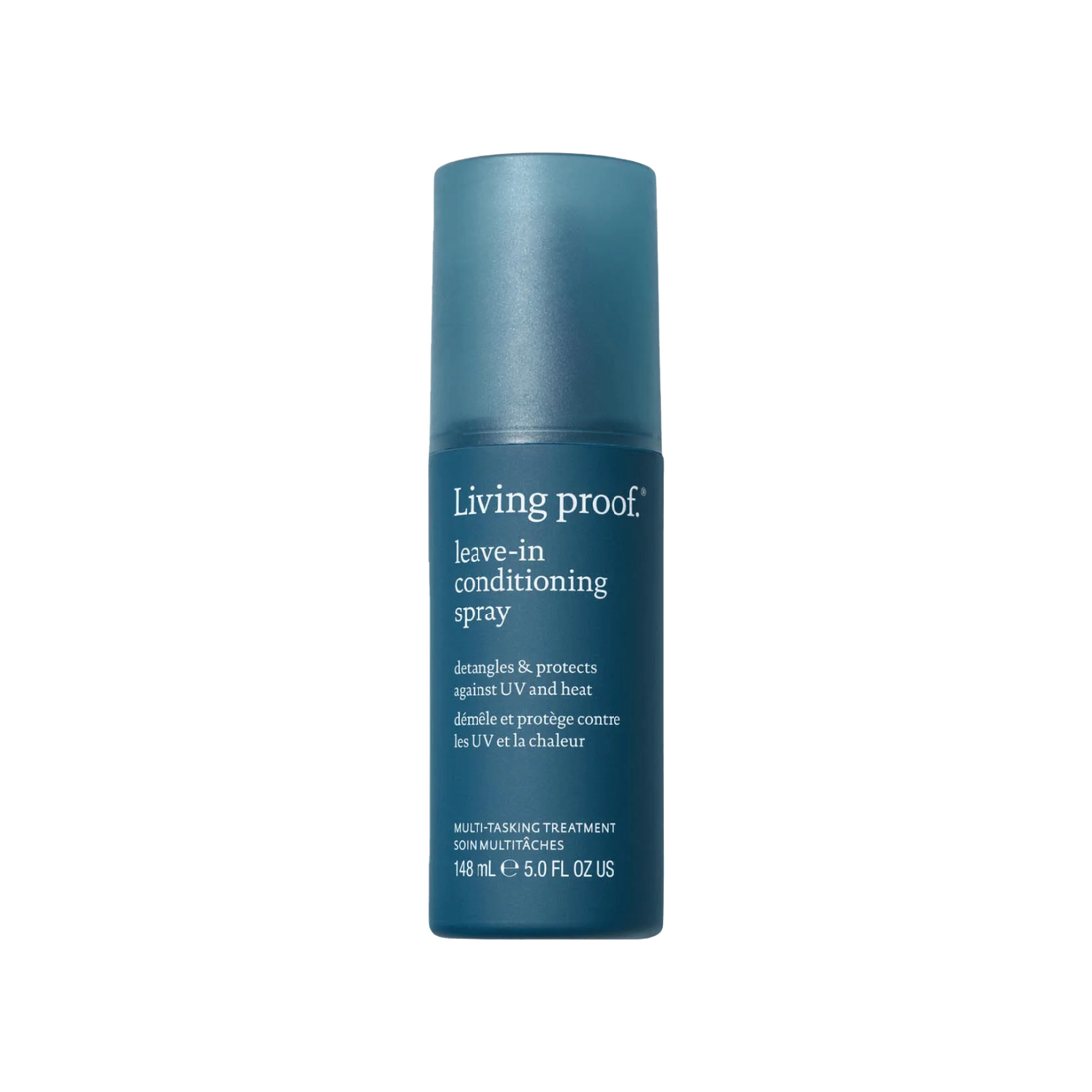 Flacon de spray sans rinçage Living Proof posé sur une surface claire, avec un fond neutre et des cheveux démêlés en arrière-plan

