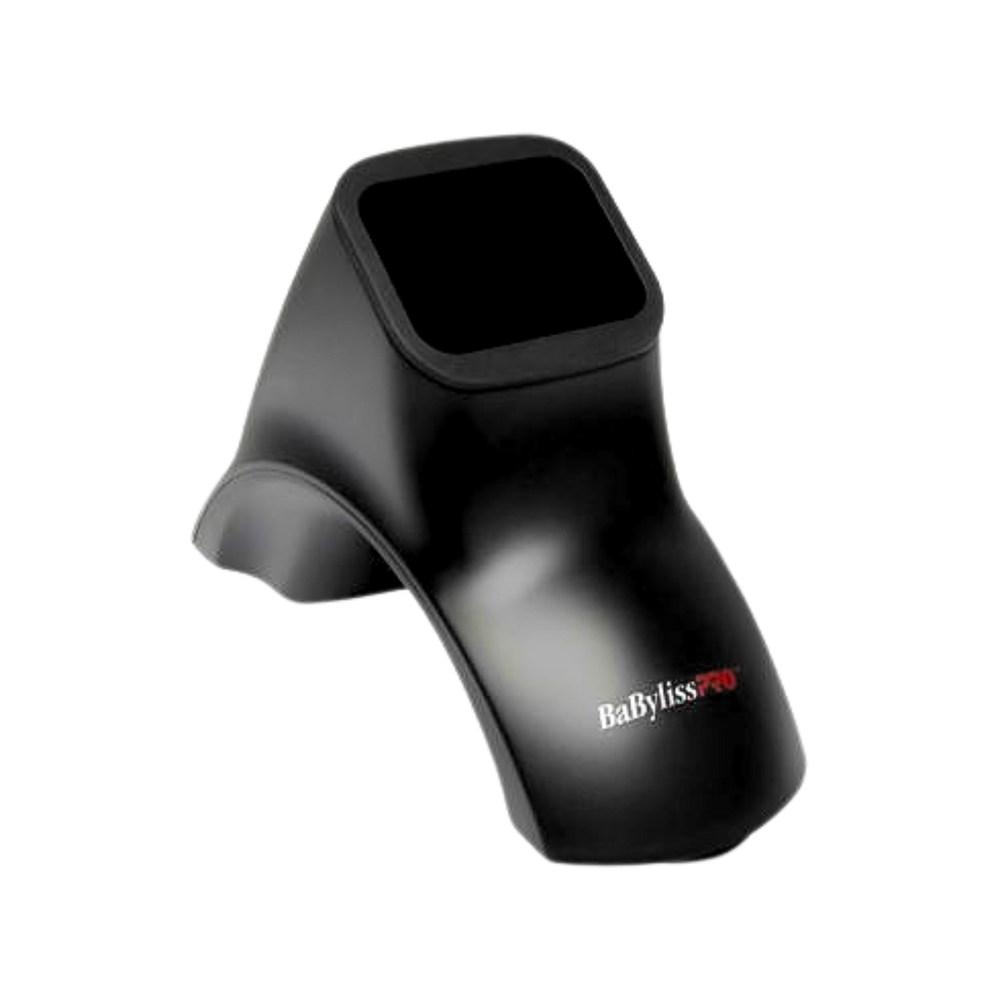 « Support universel BaBylissPRO monté sur mur, ventouses visibles, fer à lisser posé dessus »